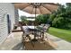 This home features a patio and deck that have an outdoor dining set with seating for four and large umbrellas at 10601 Adam Dr, Indianapolis, IN 46231