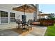 This home features a patio and deck that have an outdoor dining set with seating for four and large umbrellas at 10601 Adam Dr, Indianapolis, IN 46231