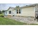 Single-story home featuring light siding, blue shutters, and decorative garden gnomes along the front flower bed at 10694 W Hickory Ct, Quincy, IN 47456
