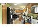 Well-equipped kitchen with wooden cabinets and black appliances, perfect for culinary enthusiasts at 10694 W Hickory Ct, Quincy, IN 47456