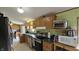 This practical kitchen is equipped with wooden cabinetry and essential appliances for preparing your favorite meals at 10694 W Hickory Ct, Quincy, IN 47456