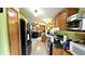 Functional kitchen featuring wooden cabinets, modern appliances, and a view into the dining area at 10694 W Hickory Ct, Quincy, IN 47456