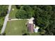Aerial view of property showing home, swimming pool, and surrounding trees at 11059 W Old Nashville Rd, Columbus, IN 47201