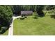 Aerial view of a home featuring a well-maintained lawn, deck, and convenient storage shed at 11059 W Old Nashville Rd, Columbus, IN 47201