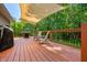 Comfortable back deck features a grill, seating area, wooden railing, and shade covering for outdoor entertaining at 11059 W Old Nashville Rd, Columbus, IN 47201