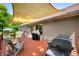 Inviting back deck features a grill, seating area, wooden railing, and shade covering for outdoor entertaining at 11059 W Old Nashville Rd, Columbus, IN 47201