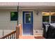 Exterior shot of back door leading onto deck and patio area, with overhead lighting fixture at 11059 W Old Nashville Rd, Columbus, IN 47201