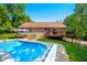 Spacious backyard with an in-ground pool, umbrella, seating, and a deck, perfect for outdoor relaxation and entertainment at 11059 W Old Nashville Rd, Columbus, IN 47201