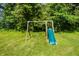 Backyard featuring a swing set with slide, offers a fun and engaging space for outdoor play at 11059 W Old Nashville Rd, Columbus, IN 47201
