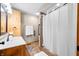 Well-lit bathroom with a tiled shower, single sink vanity, and towel bar at 11059 W Old Nashville Rd, Columbus, IN 47201