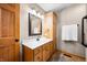 Bathroom featuring wood vanity, overhead lighting, storage, and hand towel rack at 11059 W Old Nashville Rd, Columbus, IN 47201