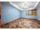 Cozy bedroom showcases blue walls, a ceiling fan, and a bright window for natural light at 11059 W Old Nashville Rd, Columbus, IN 47201