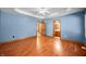 Bedroom with hardwood floors, ceiling fan, and access to an attached bathroom at 11059 W Old Nashville Rd, Columbus, IN 47201