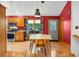 Bright dining area featuring a modern table, colorful curtains and a view to the backyard at 11059 W Old Nashville Rd, Columbus, IN 47201