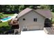 View of a home featuring an in-ground pool, covered deck, and a two-car garage at 11059 W Old Nashville Rd, Columbus, IN 47201
