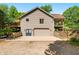 Rear exterior view with an attached garage, second story deck and well-maintained landscaping creates a welcoming and functional home exterior at 11059 W Old Nashville Rd, Columbus, IN 47201