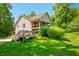 Charming two-story home with a wooden deck overlooking a lush green lawn at 11059 W Old Nashville Rd, Columbus, IN 47201
