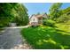 Charming home with a long driveway, lush lawn, deck, and convenient storage shed at 11059 W Old Nashville Rd, Columbus, IN 47201