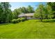 Well-maintained home with a large yard and mature trees, perfect for outdoor enjoyment at 11059 W Old Nashville Rd, Columbus, IN 47201