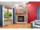 Close-up of the living room fireplace with brick surround and wooden mantle at 11059 W Old Nashville Rd, Columbus, IN 47201