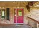 Inviting front porch with a vibrant red door and brick accents at 11059 W Old Nashville Rd, Columbus, IN 47201