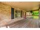 Charming covered front porch with brick detailing and a welcoming entrance at 11059 W Old Nashville Rd, Columbus, IN 47201