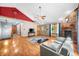 Spacious living room with hardwood floors, brick fireplace, and comfortable seating at 11059 W Old Nashville Rd, Columbus, IN 47201