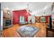 Bright living room with fireplace, blue rug, and seamless flow to kitchen and dining area at 11059 W Old Nashville Rd, Columbus, IN 47201