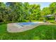 Backyard with inviting in-ground swimming pool, lush green lawn, lounge chairs, and mature trees at 11059 W Old Nashville Rd, Columbus, IN 47201