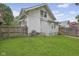 Green backyard with fence, detached garage, and space for entertaining at 113 N Munsie St, Indianapolis, IN 46229