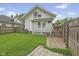 Lush backyard with fence, detached garage, patio and mature trees at 113 N Munsie St, Indianapolis, IN 46229