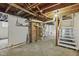 Unfinished basement with exposed ductwork, brick feature and water heater at 113 N Munsie St, Indianapolis, IN 46229