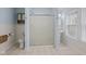 Full bathroom with frosted glass shower doors, ceramic tile floors, and sky blue walls at 113 N Munsie St, Indianapolis, IN 46229