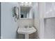 Bathroom featuring pedestal sink, mirrored medicine cabinet, and soft blue walls at 113 N Munsie St, Indianapolis, IN 46229