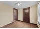 Bedroom with hardwood floors, ceiling fan, and access to additional rooms at 113 N Munsie St, Indianapolis, IN 46229
