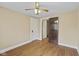 Bedroom with wood-look flooring, ceiling fan, and two closets at 113 N Munsie St, Indianapolis, IN 46229