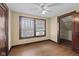 Bedroom featuring hardwood floors, updated windows, and convenient closet access at 113 N Munsie St, Indianapolis, IN 46229
