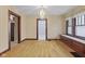 Dining room with hardwood floors, a built in bench beneath a window, and chandelier lighting at 113 N Munsie St, Indianapolis, IN 46229
