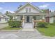 Inviting two-story home with a charming front porch and well-manicured landscaping at 113 N Munsie St, Indianapolis, IN 46229