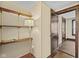 Hallway featuring built-in shelving and an open doorway at 113 N Munsie St, Indianapolis, IN 46229