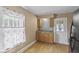 Updated kitchen featuring modern backsplash, light wood cabinets, stainless steel sink, and ample natural light at 113 N Munsie St, Indianapolis, IN 46229