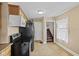 Traditional kitchen featuring black appliances and a stairway view at 113 N Munsie St, Indianapolis, IN 46229