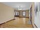 Spacious room with hardwood floors, natural light, and open archway leading to dining area at 113 N Munsie St, Indianapolis, IN 46229