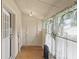 Bright sunroom with linoleum floors, radiator and multiple windows at 113 N Munsie St, Indianapolis, IN 46229
