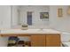 Bathroom with white counter, sink, wooden cabinets and a framed mirror at 11532 Glenn Abbey Ln, Indianapolis, IN 46235