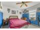 Unique bedroom with blue accents, sports memorabilia, and a ceiling fan at 11532 Glenn Abbey Ln, Indianapolis, IN 46235