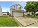 Charming two-story home with a gray exterior, brick accents, and a spacious two-car garage at 11532 Glenn Abbey Ln, Indianapolis, IN 46235