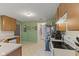 Functional kitchen featuring classic white appliances, wood cabinetry, and ample counter space at 11532 Glenn Abbey Ln, Indianapolis, IN 46235