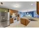 Well-lit kitchen featuring stainless steel appliances, wood cabinetry, and a functional layout at 11532 Glenn Abbey Ln, Indianapolis, IN 46235