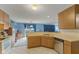 Bright kitchen with a pass-through window, stainless steel dishwasher, and ample cabinet space at 11532 Glenn Abbey Ln, Indianapolis, IN 46235